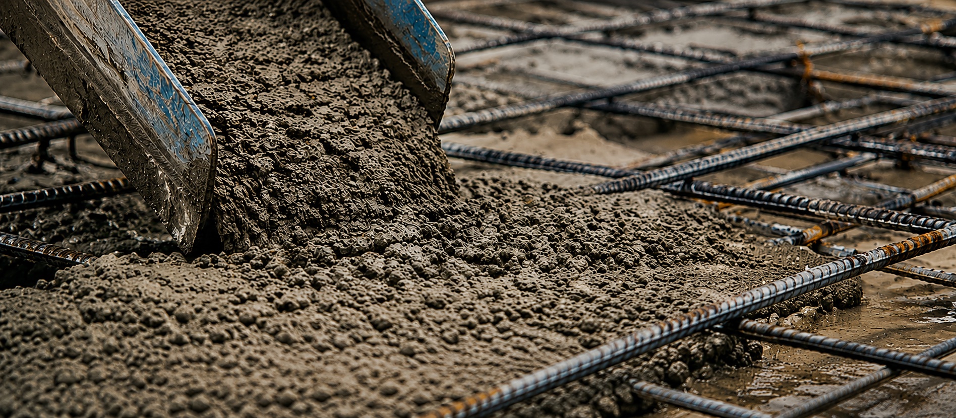 Concrete being poured onto reinforced rebar formwork, representing engineering precision